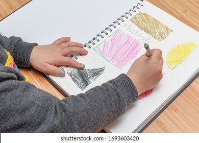 Child Learning At Home. Pre School Age Child Learning About Shapes And Hand Writing