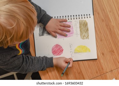 Child Learning At Home. Pre School Age Child Learning About Shapes And Hand Writing