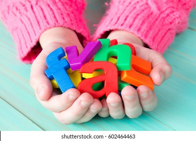 Child Learning To Read Using Magnetic Letters. Education School  Concept