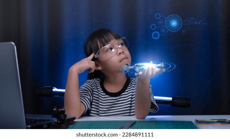 Child learning repairing getting lesson control toy drone in workshop, coding and solving engineering problem at home. Little Scientist School Project. STEM Education and Science technology concept. - Powered by Shutterstock