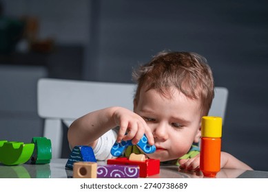 Child learning through play while stacking wooden blocks in a calm home environment.