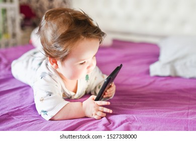 Child Learns By Mobile Phone. Little Newborn Baby Reaching For A Mobile Phone 