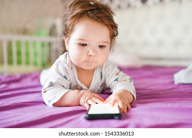 Child Learns By Mobile Phone. Little Newborn Baby Reaching For A Mobile Phone 