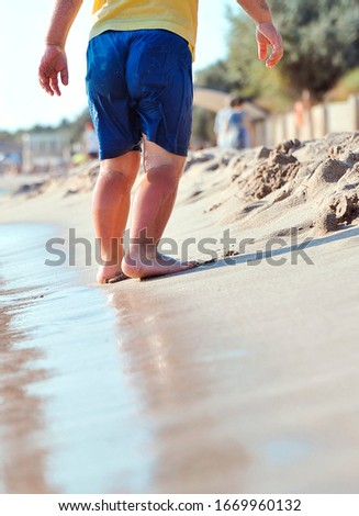 Child legs on sand texture.
