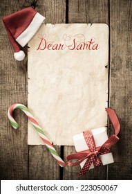 Child Letter To Santa Claus. Christmas Decorations And Old Paper With Place For Greeting On Old Paper Blackboard. 