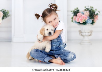 Child With Little Dogs Playing At Home. Girl With Puppies. Chid With Puppy. Kissing, Hugging, Playing In Room