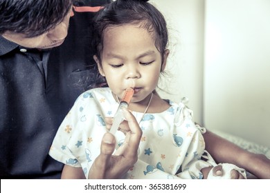 Child Little Girl Gets Medicine With A Syringe In Her Mouth In Vintage Color Tone