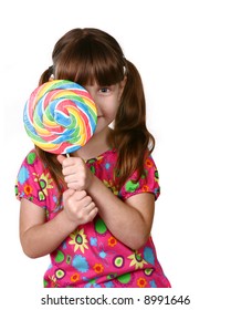 Child Looking From Behind Large Lolipop On White Background