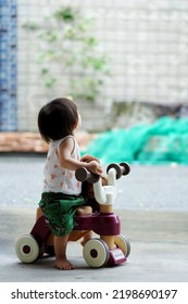 A Child Looking Up At The Rainy Season Sky            