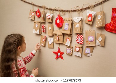 Child Looks At The Advent Calendar. Option DIY To Wait For Christmas For Kids.