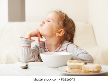 Child Looks With Disgust For Food.