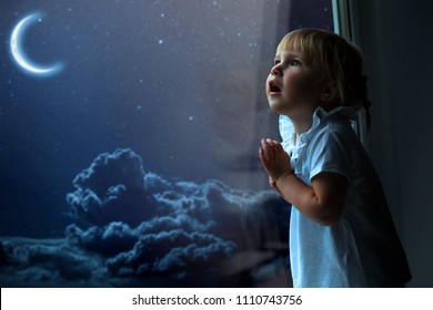 The Child Looks Out The Window Into The Night Sky