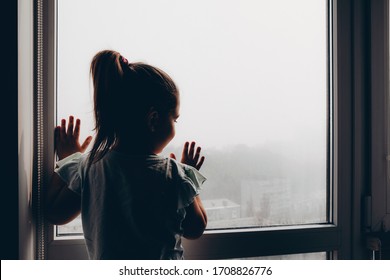 Child Looks Out The Window At Smog In The City Of Kiev. Fog. Air Pollution Is An Environmental Disaster. Kiev Leader In Air Pollution In The  World         