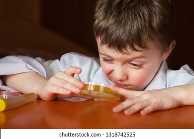 A child looks at a Petri dish with cell culture - Powered by Shutterstock