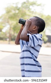 Child Looks Through The Binoculars To Search His Mark.