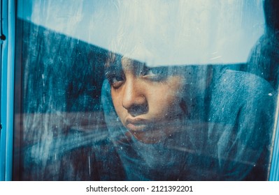 Child Looks Through Old Glass Window