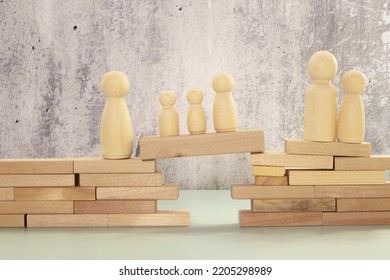 The Child Was Lost In The Crowd. A Crowd Of Wooden Figures Of People Surround A Lost Child. Lost, Parents Who Have Lost Their Parents Are A Small Child. An Orphan, A Beggar, A Lonely Kid