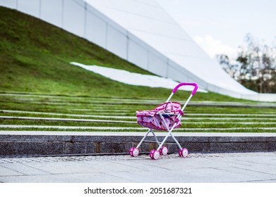 The Child Lost Pink Pram. Baby Stroller Forgotten In A City. Toy Carriage For Dolls Left On The Street. Lost Children Concept