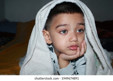 The child is lying in bed
