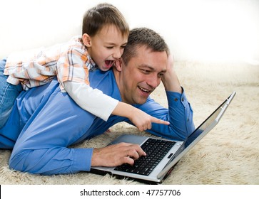 child lying on his back with his father