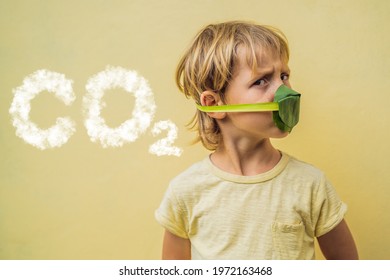 The child made himself a face mask from the leaves to protect himself from air pollution. CO2 lettering made of clouds. Sky with CO2 pollution, smog. Air purification for children concept. Trees - Powered by Shutterstock