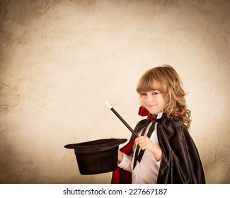 Child Magician Holding Top Hat And Magic Wand. Success Concept