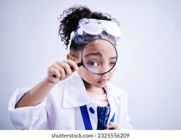 Child, magnifying glass and portrait of a scientist girl in studio with eye for scientific research. Face of a African kid student with magnifier for medical science, education or biology experiment - Powered by Shutterstock