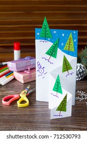 The child makes a greeting card Christmas. Made with his own hands. Children's art project craft for kids. Craft for children.
