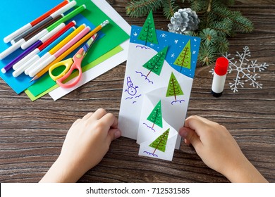 The Child Makes A Greeting Card Christmas. Made With His Own Hands. Children's Art Project Craft For Kids. Craft For Children.