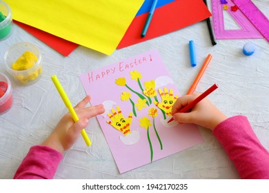 Child making card and Easter funny eggs   flowers  from colorful paper  Handmade  Project children's creativity  handicrafts  crafts for kids  Happy easter inscription
