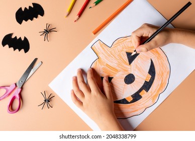 child making Halloween decorations from paper  Childrens crafts for the Halloween