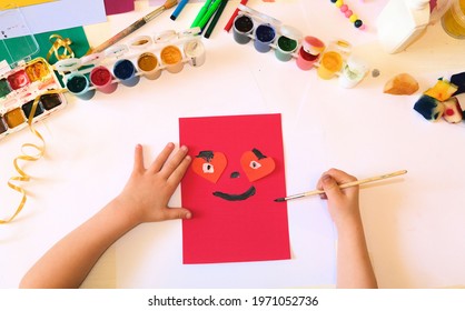 Child Making Homemade Greeting Card From Paper. Gift For Mothers Day, Fathers Day, Birthday Or Valentines Day.  Kid Craft. Home Education Game. Early Development Concept
