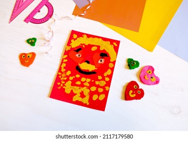 Child Making Homemade Greeting Card From Paper. Gift For Mothers Day, Fathers Day, Birthday Or Valentines Day.  Kid Craft. Home Education Game. Development Concept