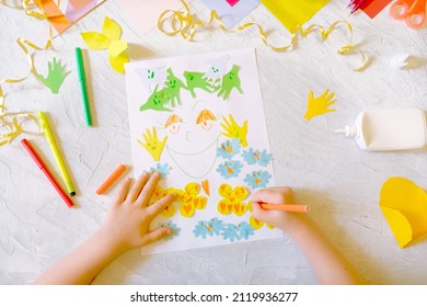 Child making homemade greeting card  little girl making card for mom and flowers from paper as gift for Mothers day  Birthday Valentines day   Arts  crafts concept 