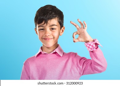 Child Making Ok Sign Over Colorful Background