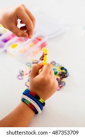 Child Making Rubber Bands Bracelet 