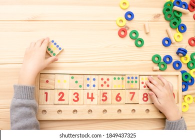 Child Math Development, Learning Center, Primary School, Sorting Skills Concept. Hands Of A Caucasian Child Playing With A Wooden Math Toy. Number Line, Counting 1-10. Top View. Desk. Horizontal. 