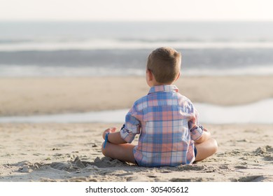 child meditates at sea