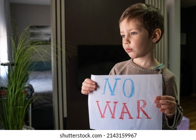 Child With Message Stop War. Child Raises A Banner With The Inscription No War. Kids Is Protesting. Activism Concept. Request For Help To World Community. Caring For Eac H Other. Military Protest.