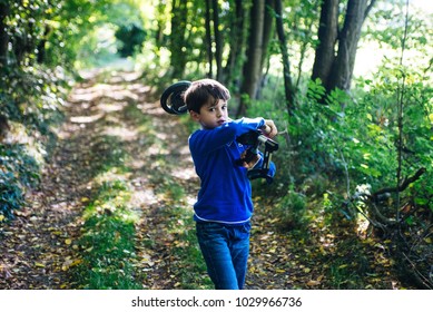 Child With Metal Detector In The Woods In Spring