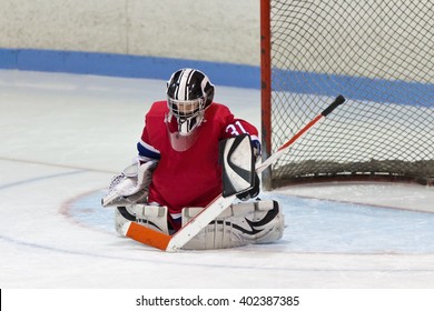 Child Minor Ice Hockey Goalie Makes A Save In Front Of Net