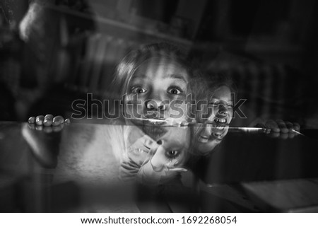 Boy with sister lighting up with flashlight