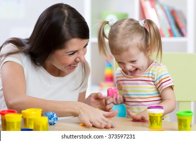 Child With Mom Make By Hands Playing With Color Dough