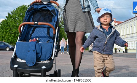 A Child With Mom And A Stroller Walk Around The City