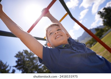 Child, monkey bars and energy on playground, smiling and obstacle course on outdoor adventure at park. Happy male person, active and exercise on jungle gym, boy and fitness on vacation or holiday