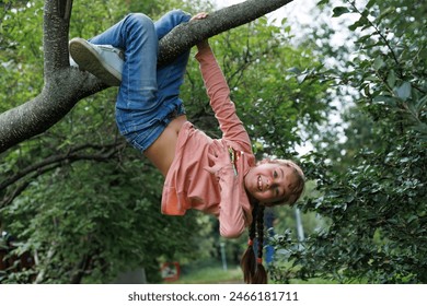 Child, monkey bars and energy on playground, smiling and obstacle course on outdoor adventure at park. Happy girl, active and exercise on jungle gym, fitness on vacation or holiday