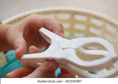 Child Motor Skills Practiced With Household Item Likes Clothes Peg, Kid Hand Reaching For A Clothespin 