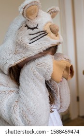 A Child In A Mouse Animal Onesie Covering Their Face And Pretending To Cry Or Be Upset