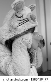 A Child In A Mouse Animal Onesie Covering Their Face And Pretending To Cry Or Be Upset