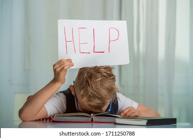 Child needs help with homework. San kid put head on table. Little boy with paper with Help word. 